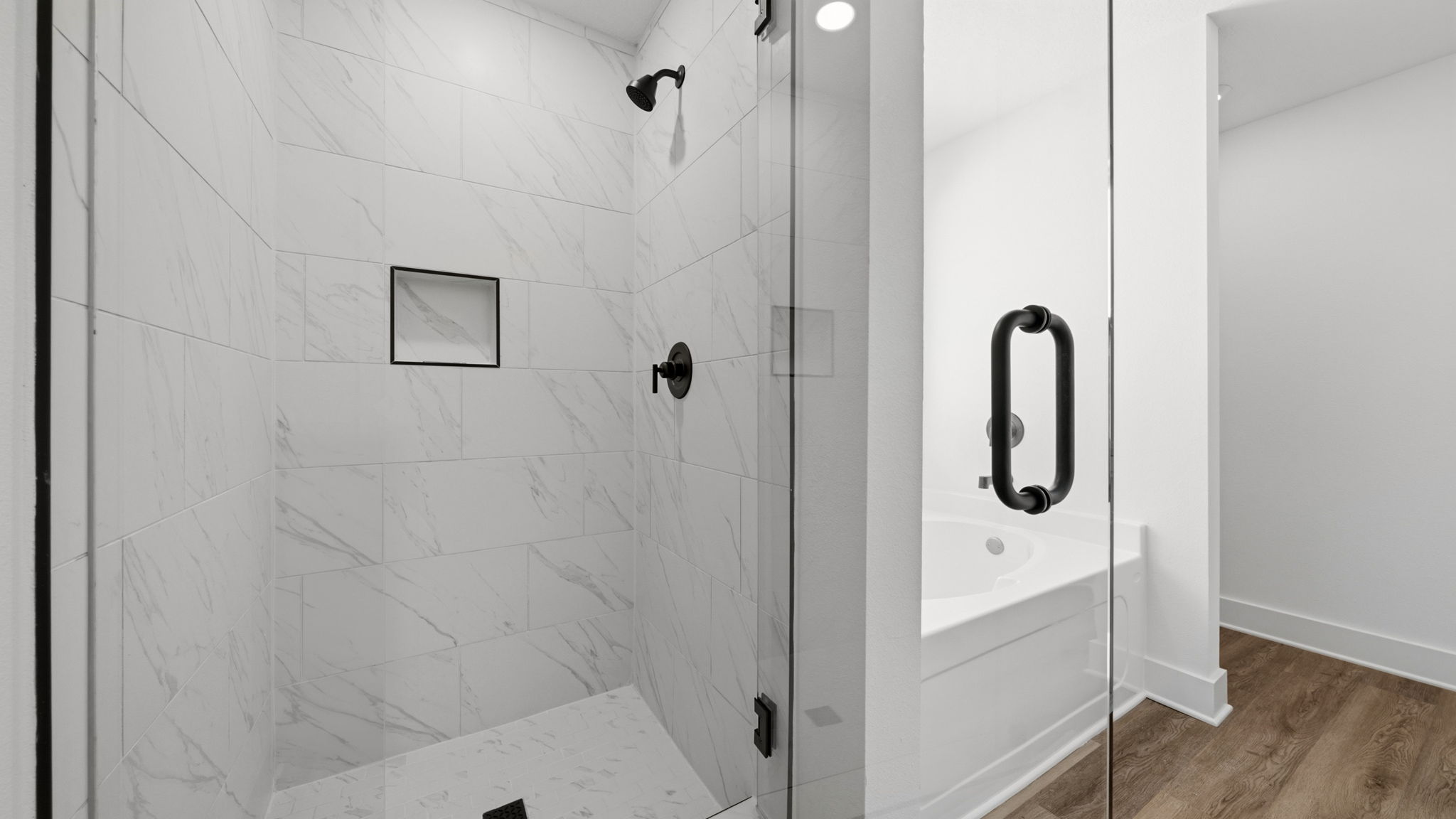 The primary bathroom has a shower and separate soak tub