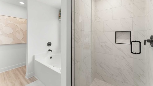 The primary bathroom has a shower and separate soak tub