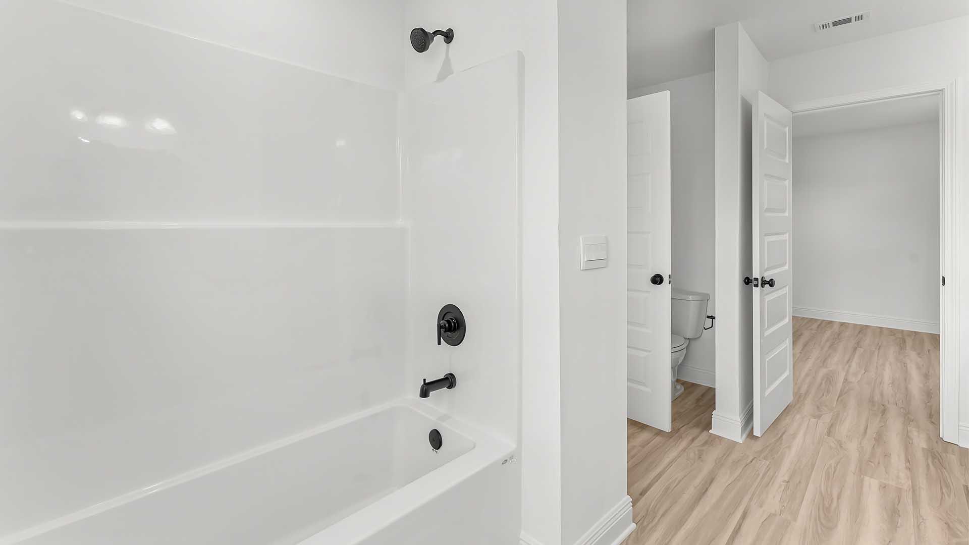 The adjoining bathroom has a shower tub combination