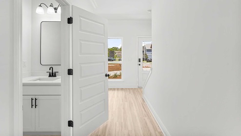 The entry hall features a half bath