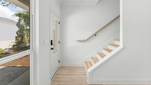 Stairs leading to add bedrooms on the second leve;