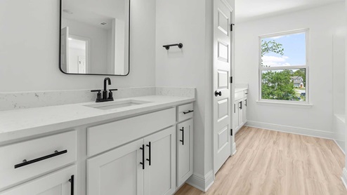 The shared bathroom is accessible from each bedroom