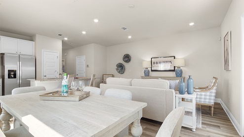 The kitchen has a center island and beautiful white cabinetry