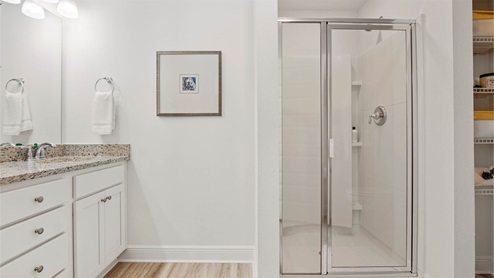 Primary bathroom with vanity and separate shower