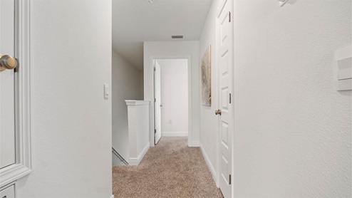 Second floor hall leading to primary bedroom