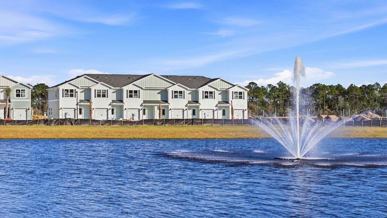 Image shows the pond at entry to community with water fountain