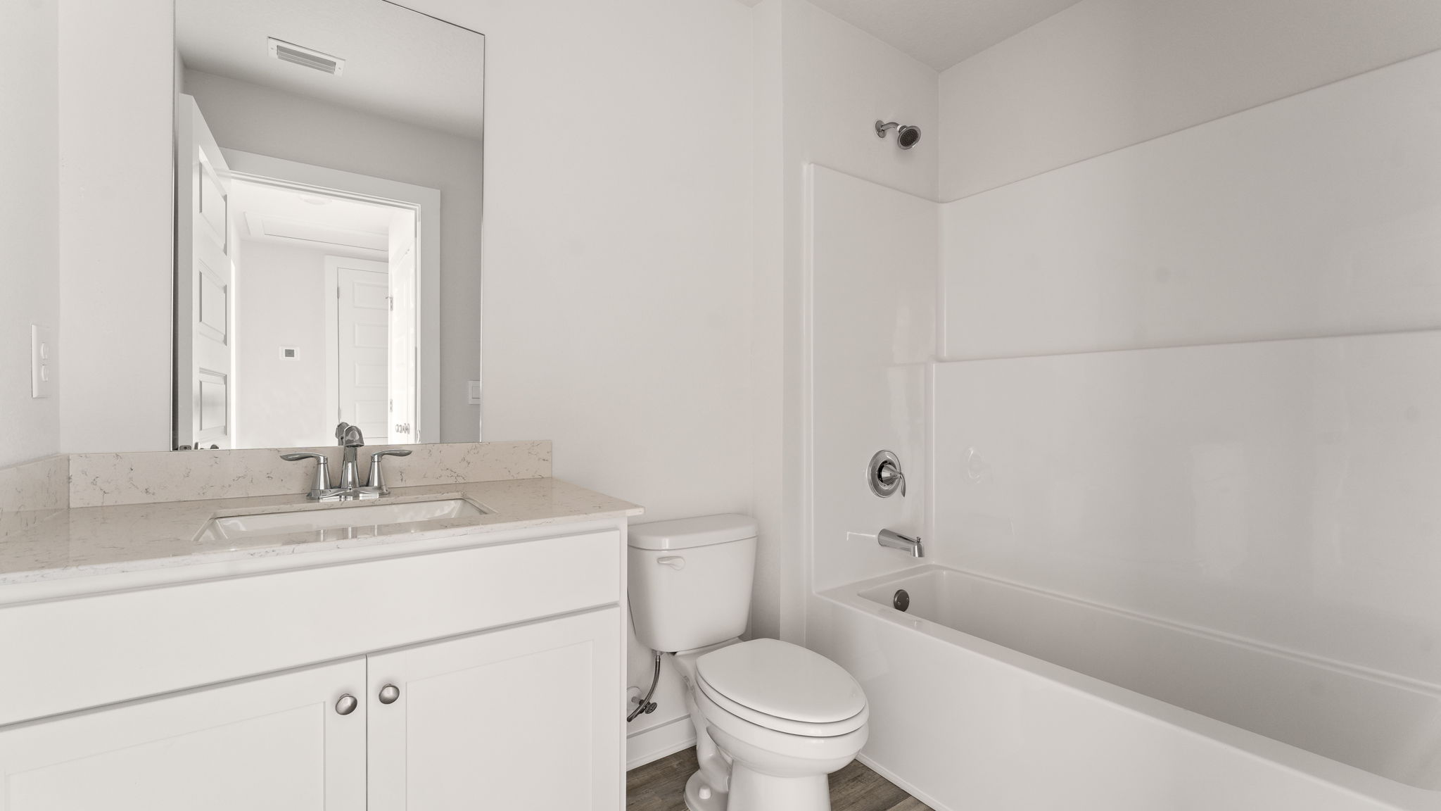 There is a shared bathroom off the guest bedrooms with a shower tub combination