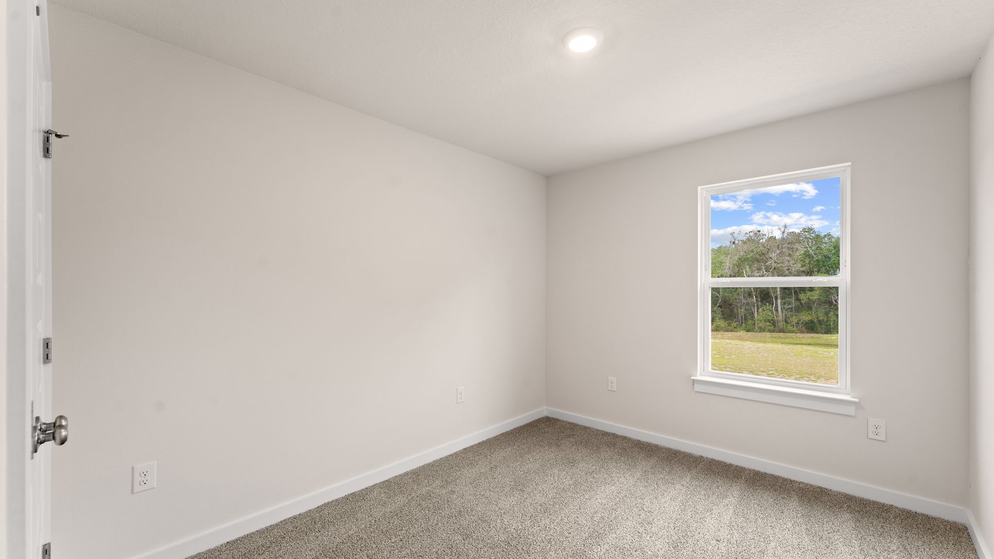 Guest bedroom one has carpet and ample closet space