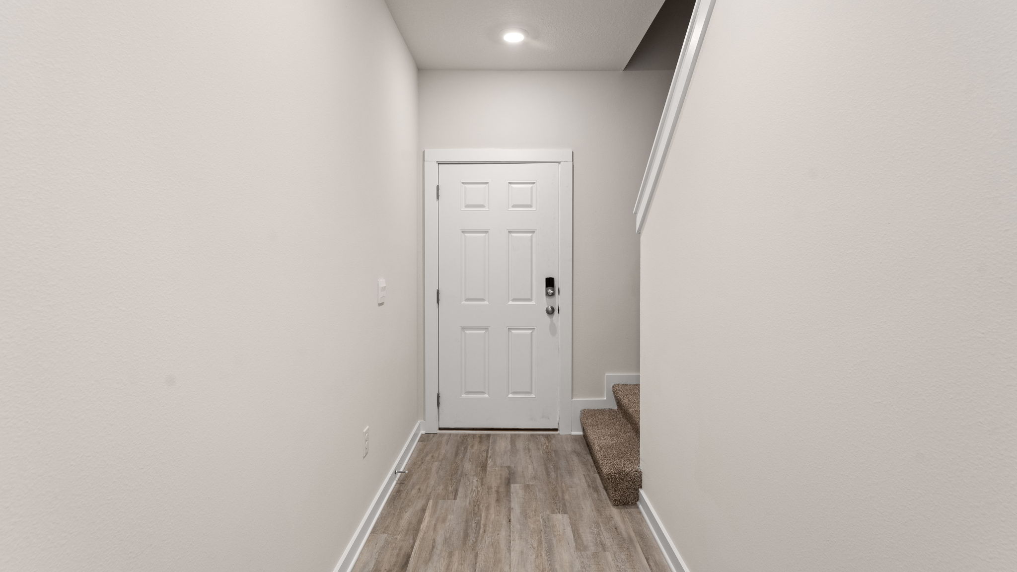 The entry hall has a half bath and access to the single car garage