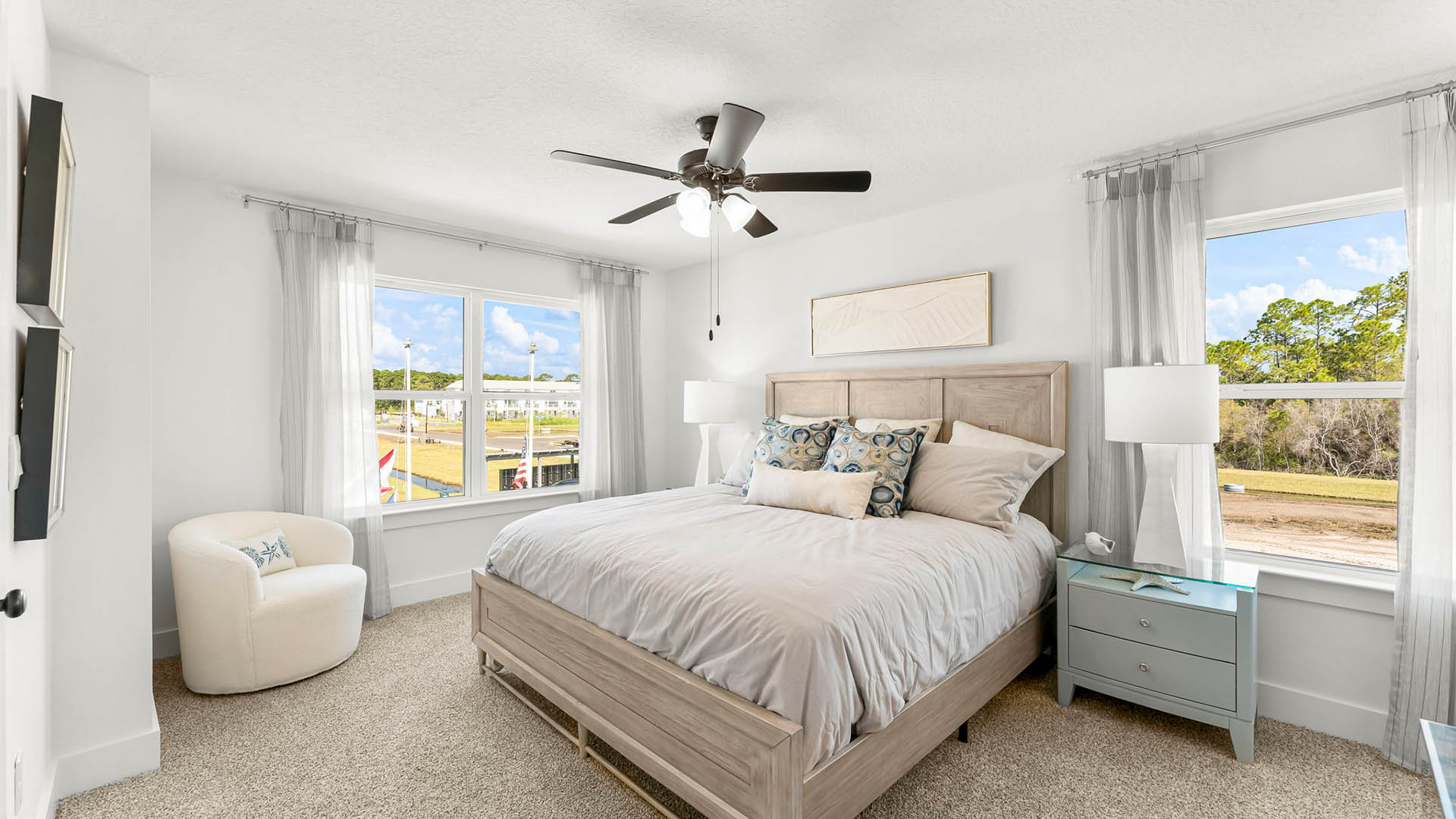 The second level primary bedroom has a ceiling fan and spacious ensuite bathroom