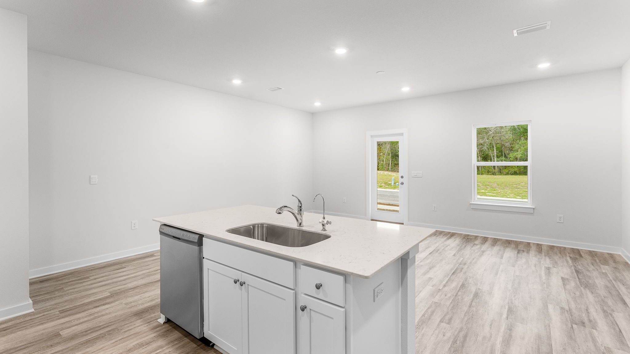 The kitchen island holds the sink and dishwasher