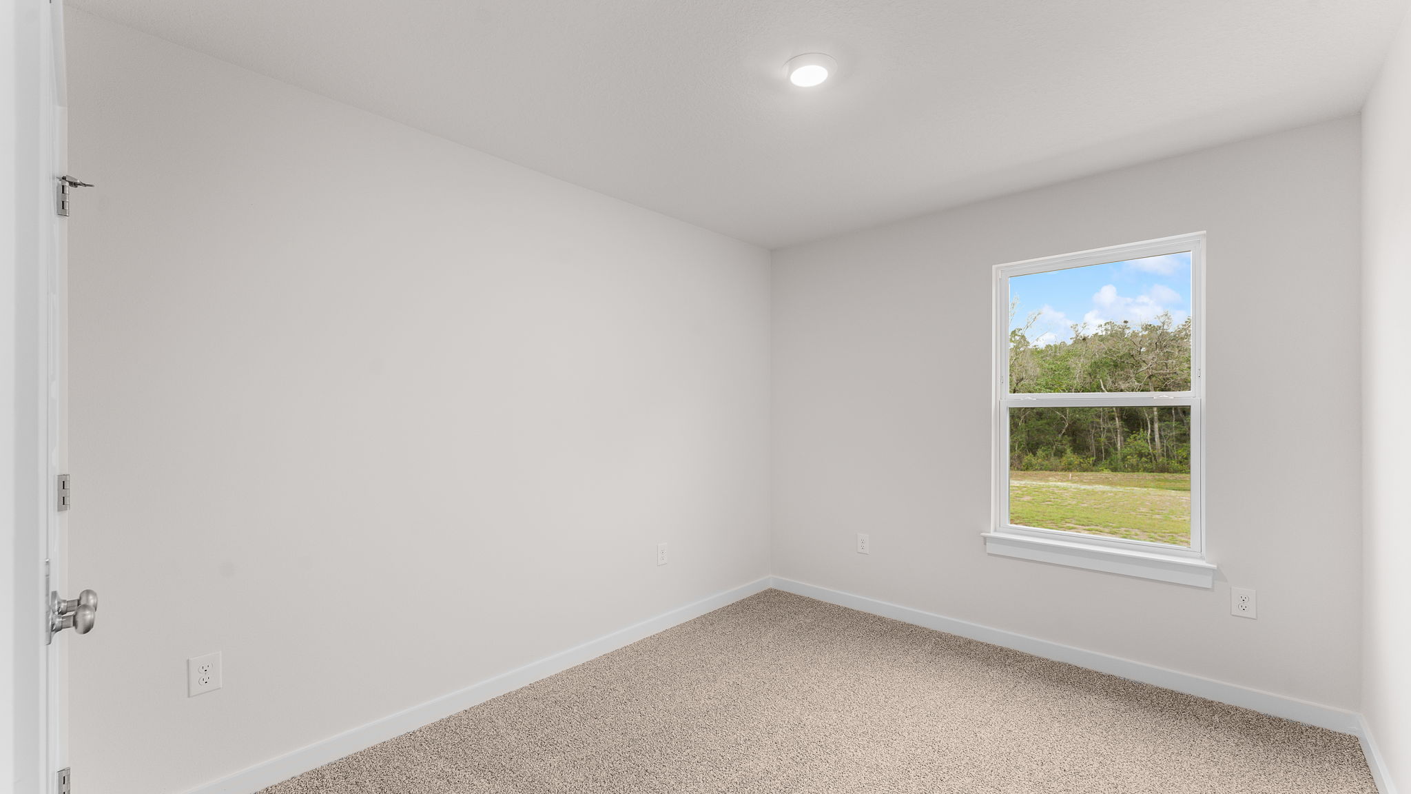 Guest bedroom one has carpet and ample closet space