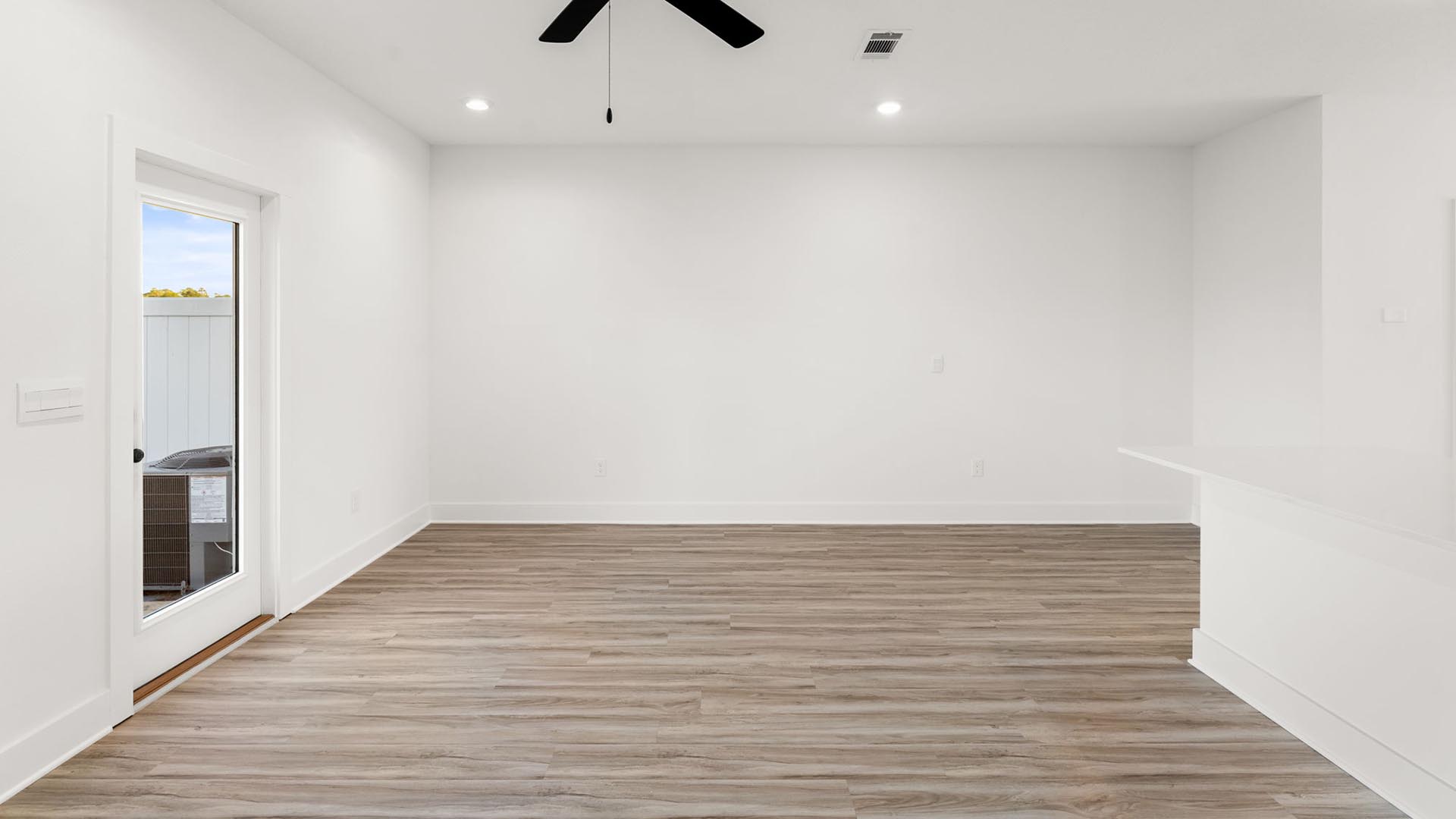 The living room has access to the back patio