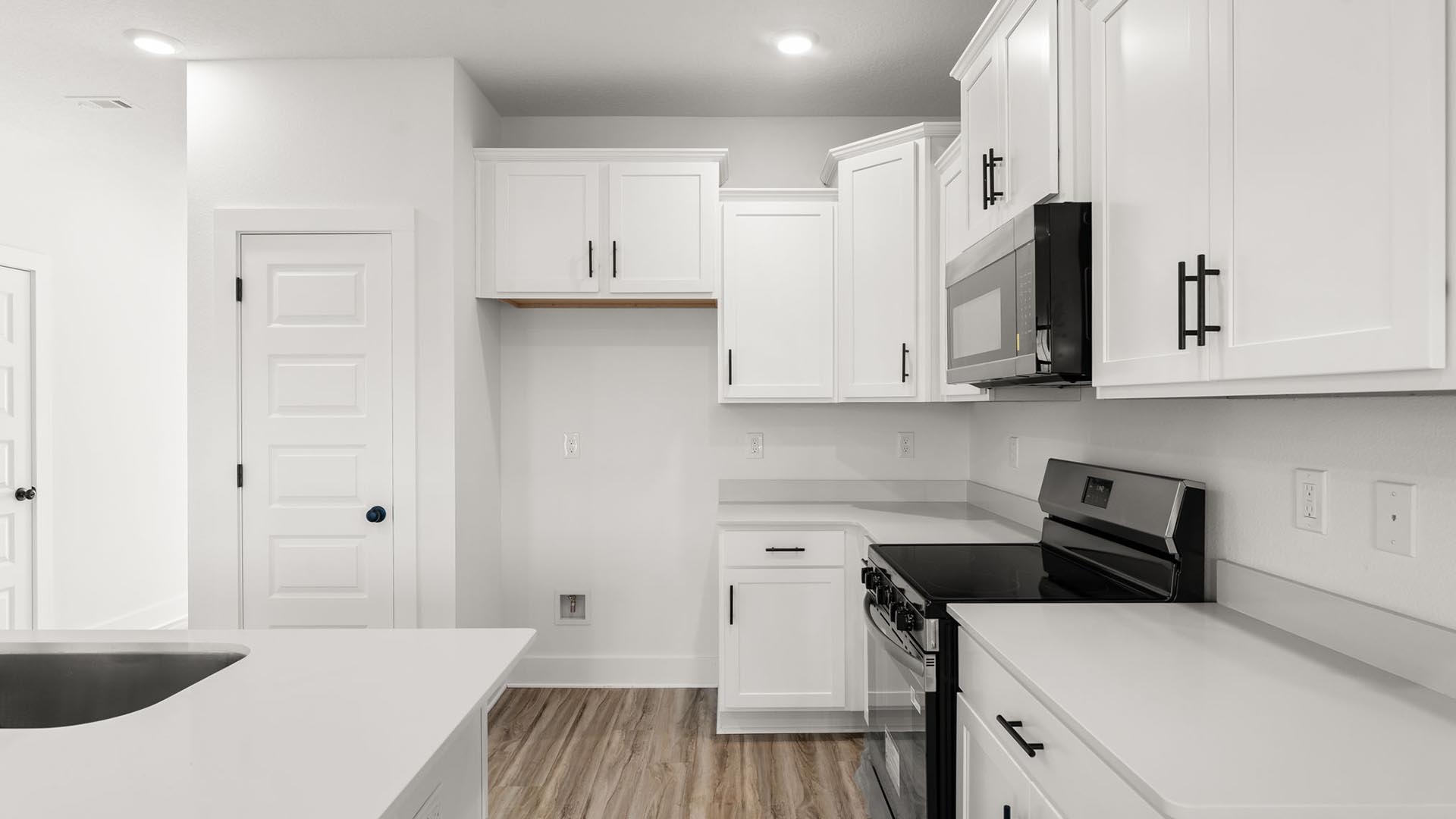 The kitchen has upper and lower cabinetry for storage