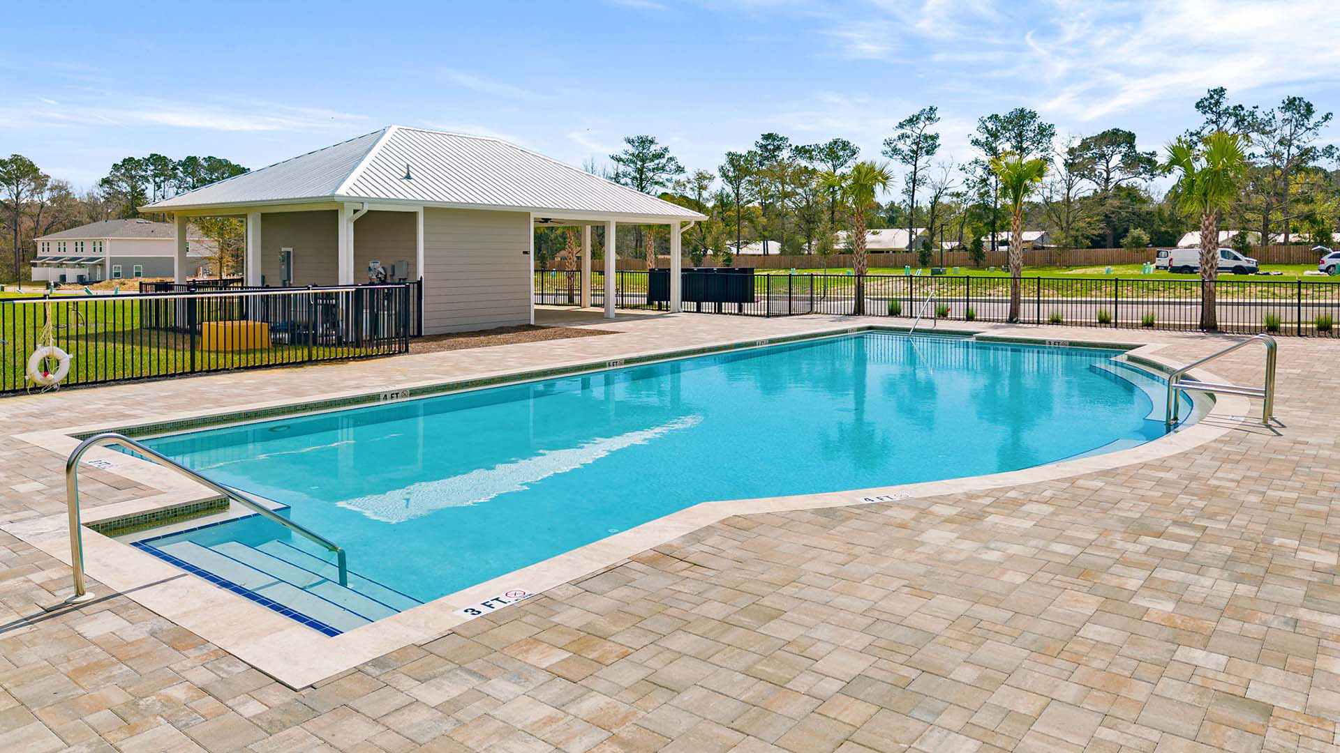The pool has a brick paver patio