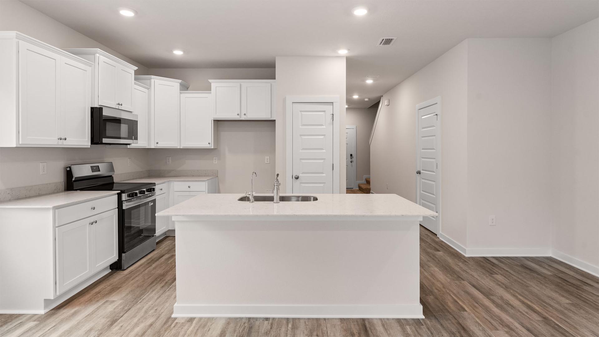 The kitchen has appliances that include a stove microwave and dishwasher