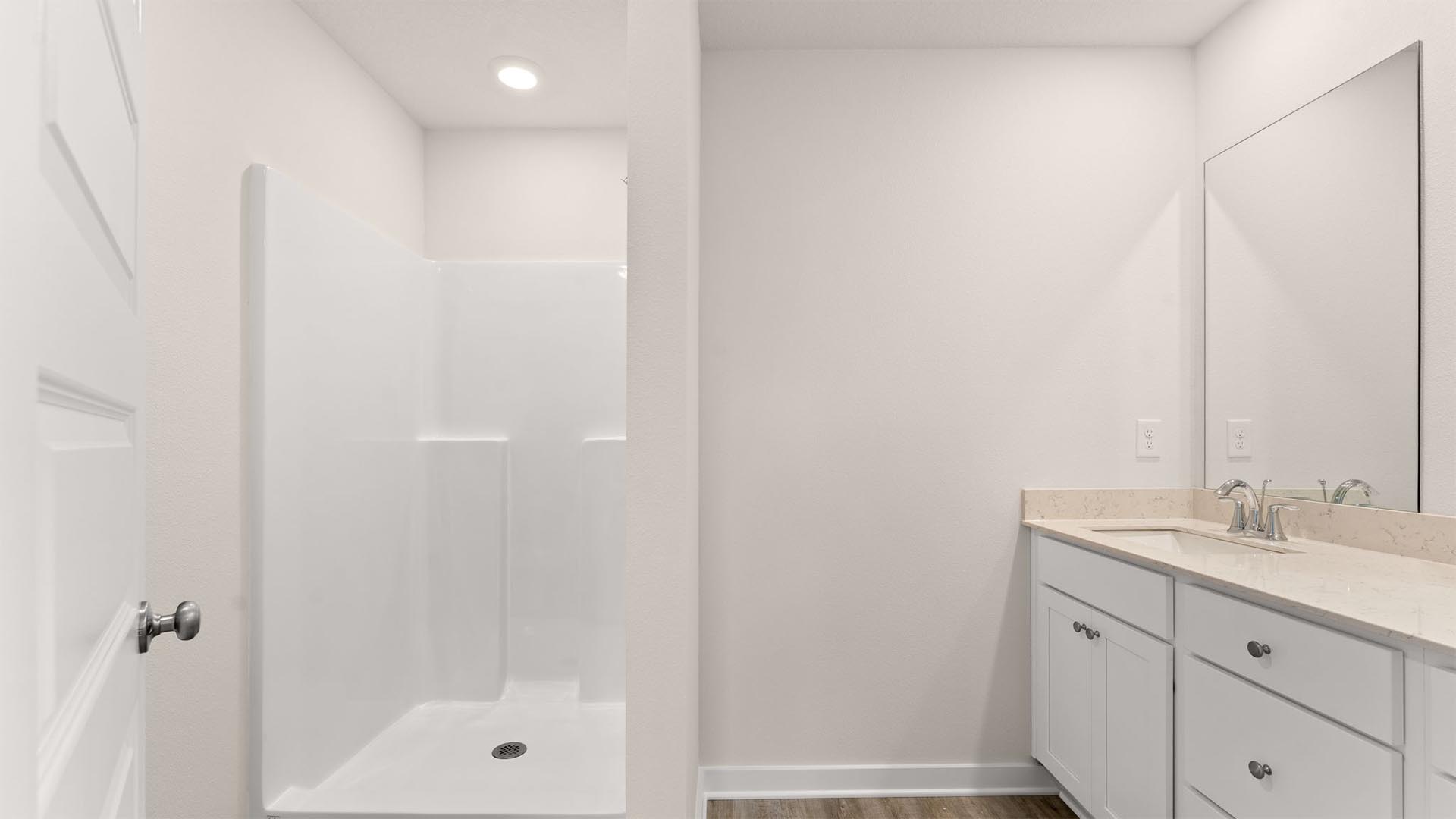 The primary bedroom is located on the second level and has an ensuite with a shower and linen storage area as well as a dual sink vanity