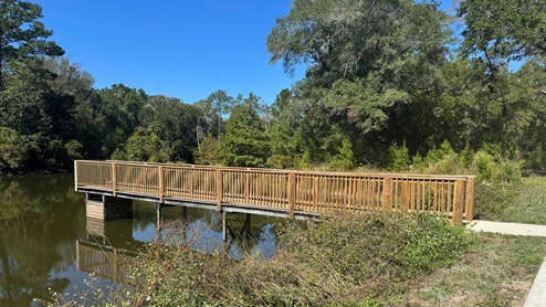 There is an accessible pond with a boardwalk