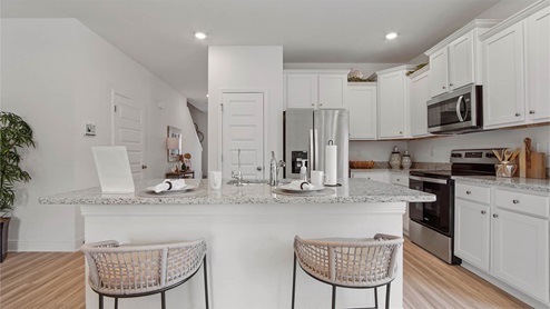 The townhomes have a center island in the kitchen and cabinetry for storage