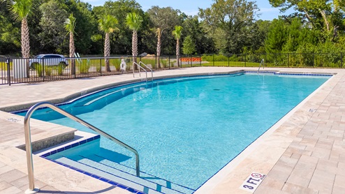 The pool is located at the back of the community