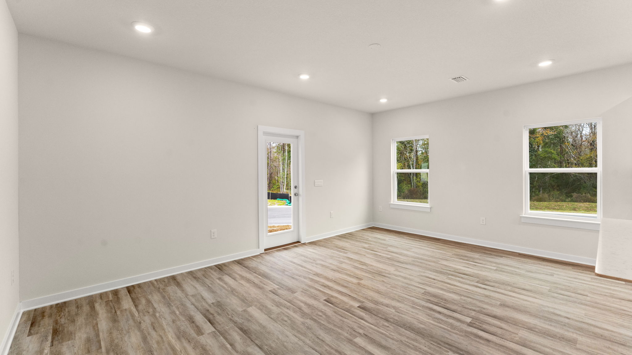 The open living area is illuminated by the many windows