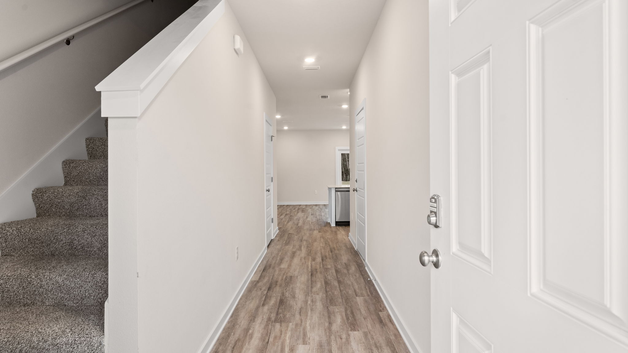 Welcome to 30 Rudder Lane at Genoa Landing Townhomes in Freeport Florida. This end unit townhome features a welcoming space that has three bedrooms, two and a half bathrooms, and a convenient single car garage.   As you enter this townhome you will find a hall leading to an open-concept kitchen, living, and dining area, designed for entertaining and everyday living. Multiple windows illuminate the living area providing natural light. The kitchen serves as the culinary center with its spacious center island and cabinetry for storage as well as a pantry. The kitchen finishes include quartz countertops, white cabinetry, chrome plumbing fixtures, and an appliance package including a smooth top stove, microwave and dishwasher.   The first floor is the heart of the home, while the privacy of the second level holds all bedrooms, ensuring a quiet retreat. The primary bedroom has a generous closet and a private bath with shower, dual sink vanity, and ample linen storage space. The additional bedrooms share a hall bath with shower tub combo, creating a comfortable space for family or guests. You will also have a laundry area on the second level with space for a full-size washer and dryer.