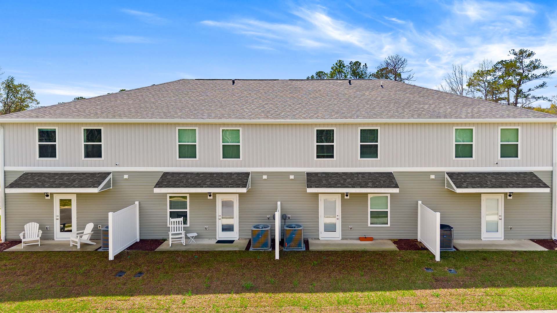 The back of the townhome has a patio and partition between units.
