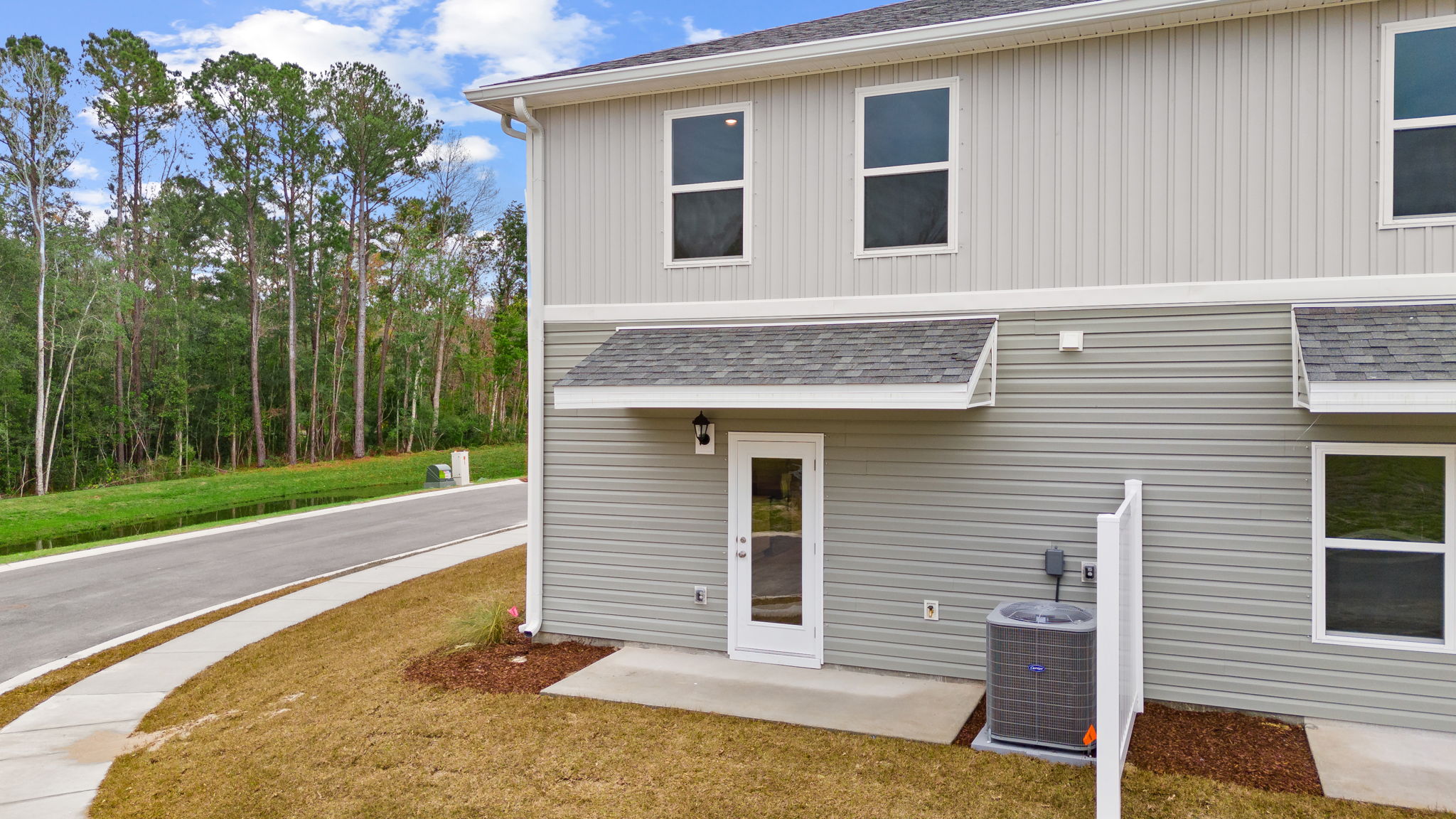 The back of the townhome has a patio and partition between units.