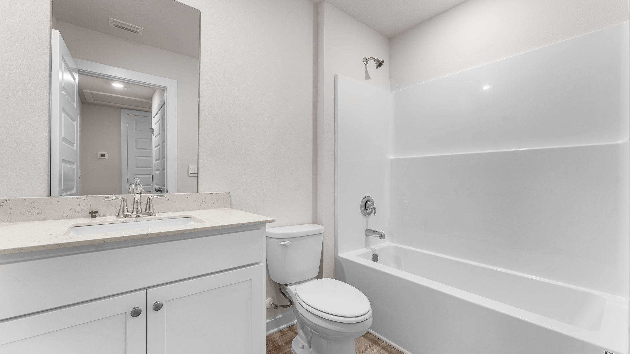 There is a shared bathroom off bedrooms two and three with a shower tub combination and vanity with lower cabinetry for storage