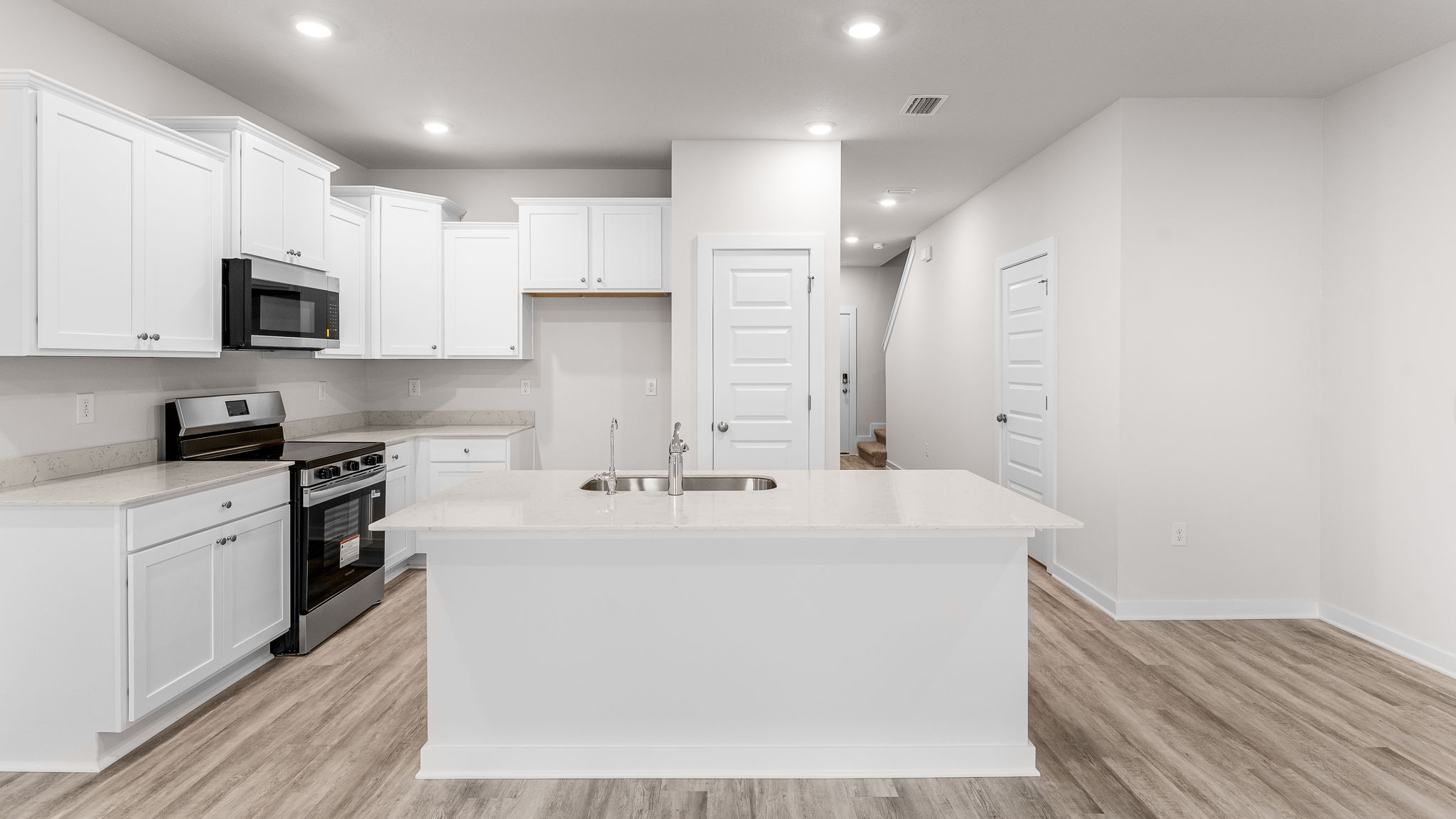 The kitchen is situated looking out to the dining and living areas