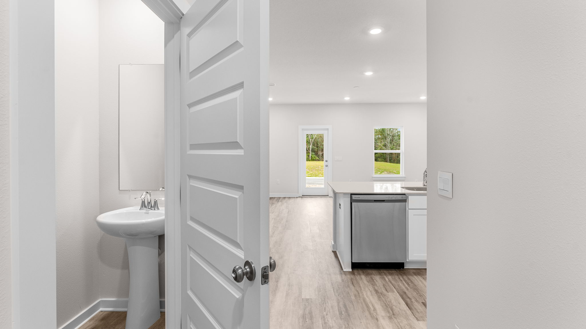 The half bath has a pedestal sink