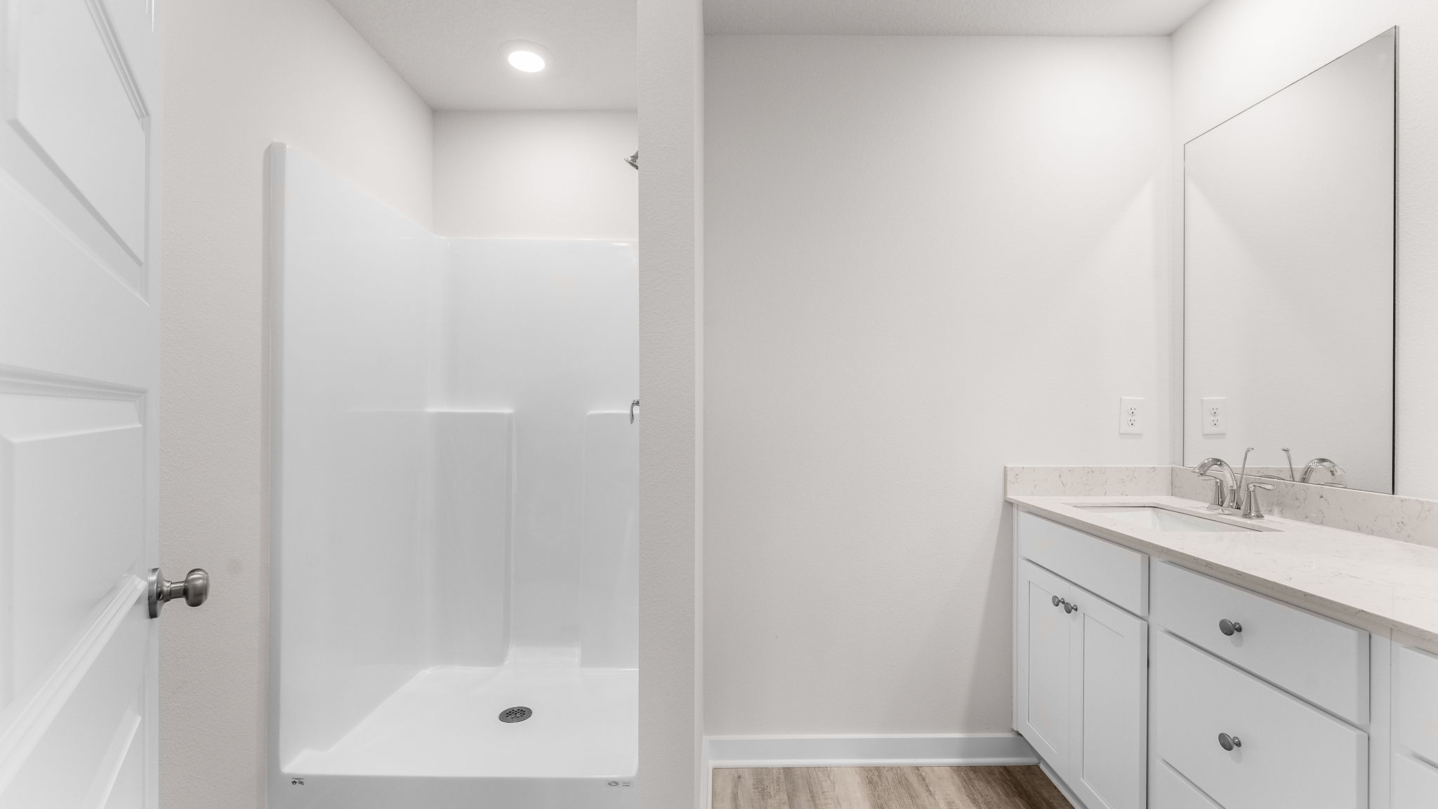 The primary bathroom has a dual sink vanity with quartz countertops