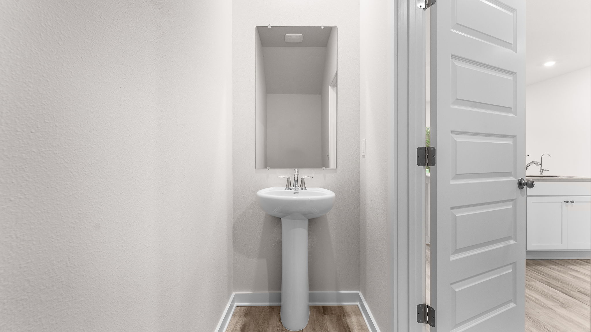 The half bath has a pedestal sink