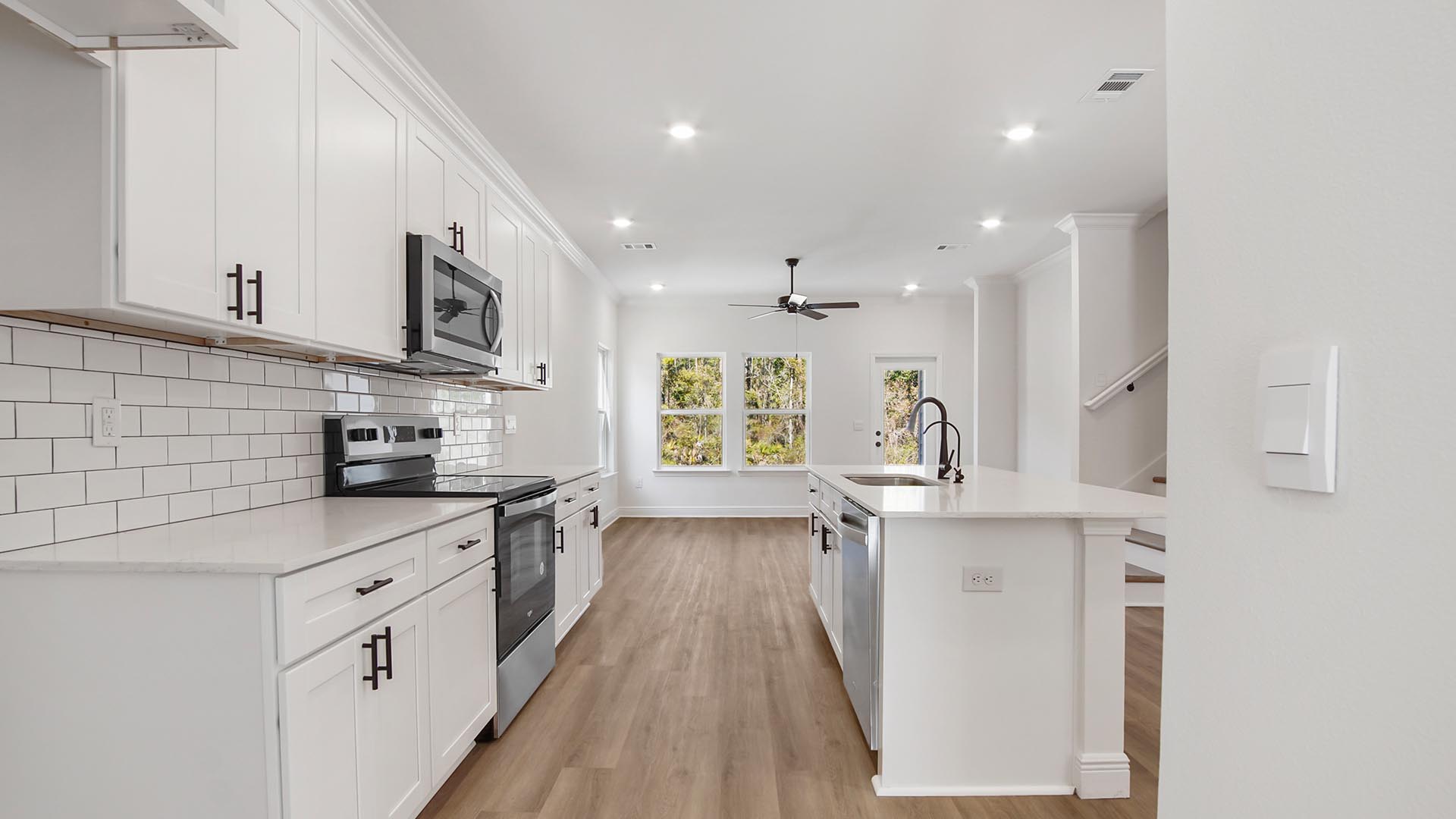 The kitchen is open and features plenty of cabinetry