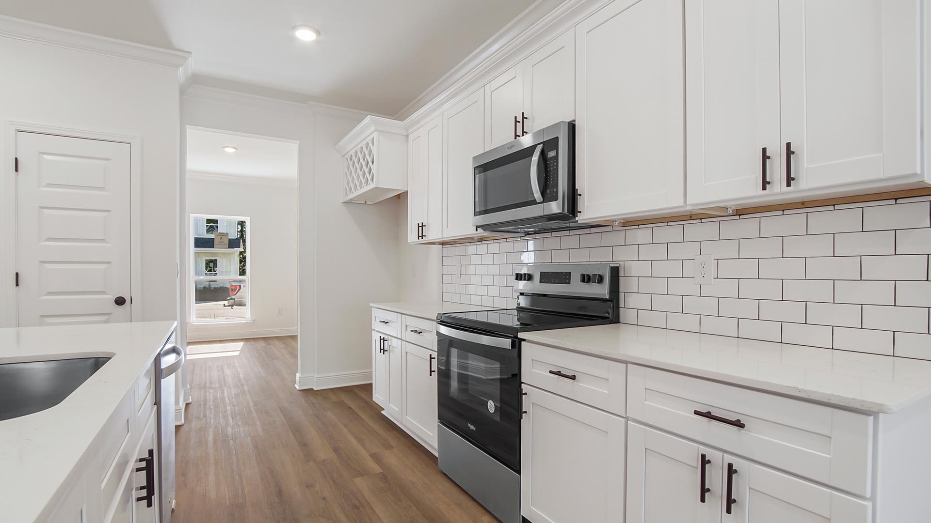 Kitchen has plenty of upper and lower cabinetry for storage