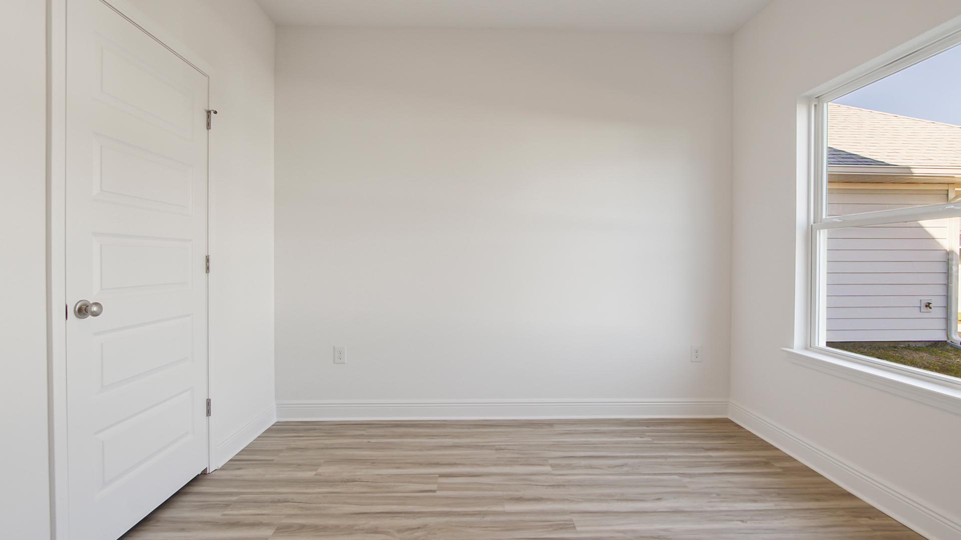 The guest bedroom on the main level is at the back of the home