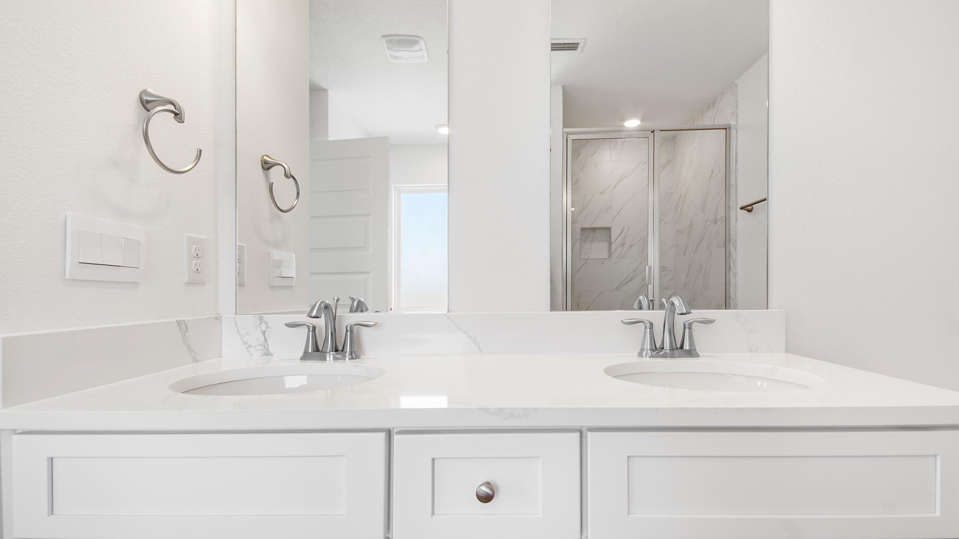 Dual sink vanity atop lower cabinetry for storage