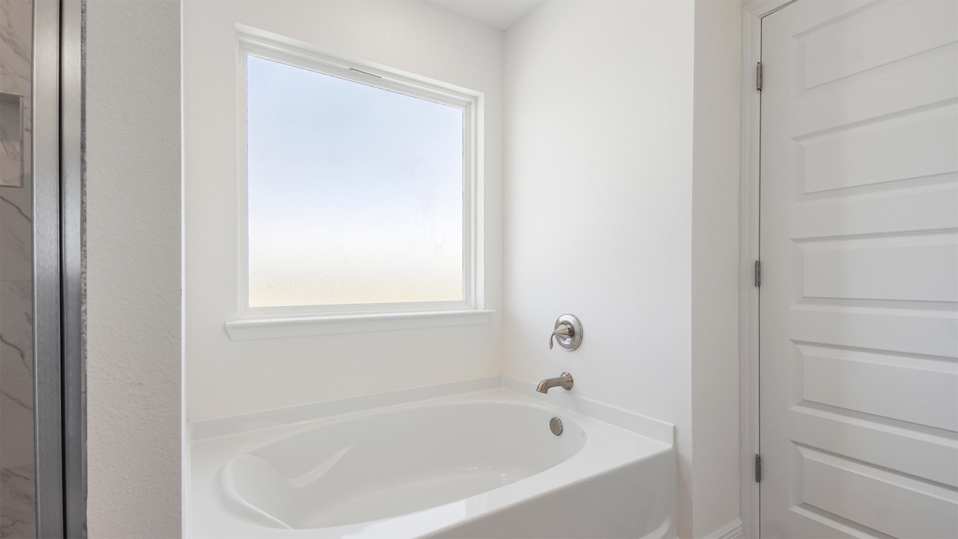 The primary bathroom features a large soak tub