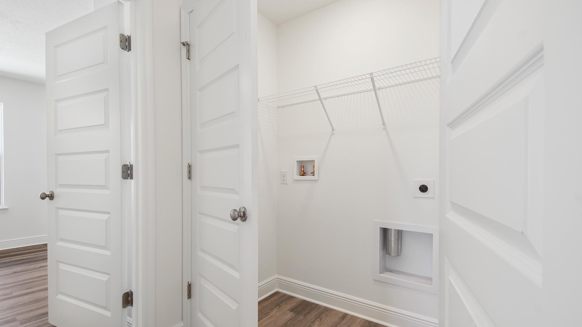 The laundry area is located off the second level landing and hall