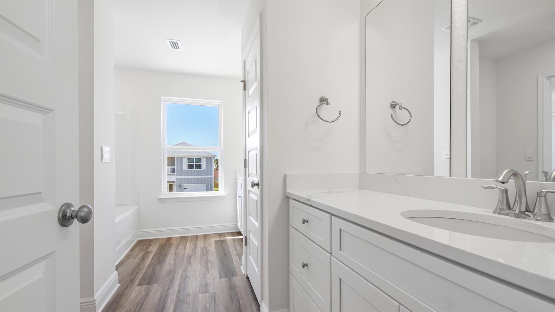 The shared bathroom has two single sink vanities