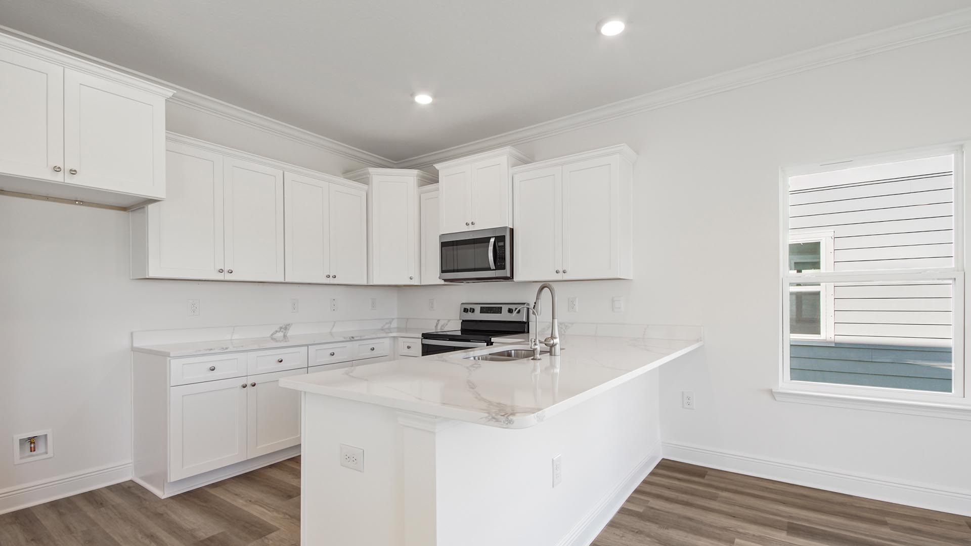 The kitchen has a peninsula design counter with space for bar seating