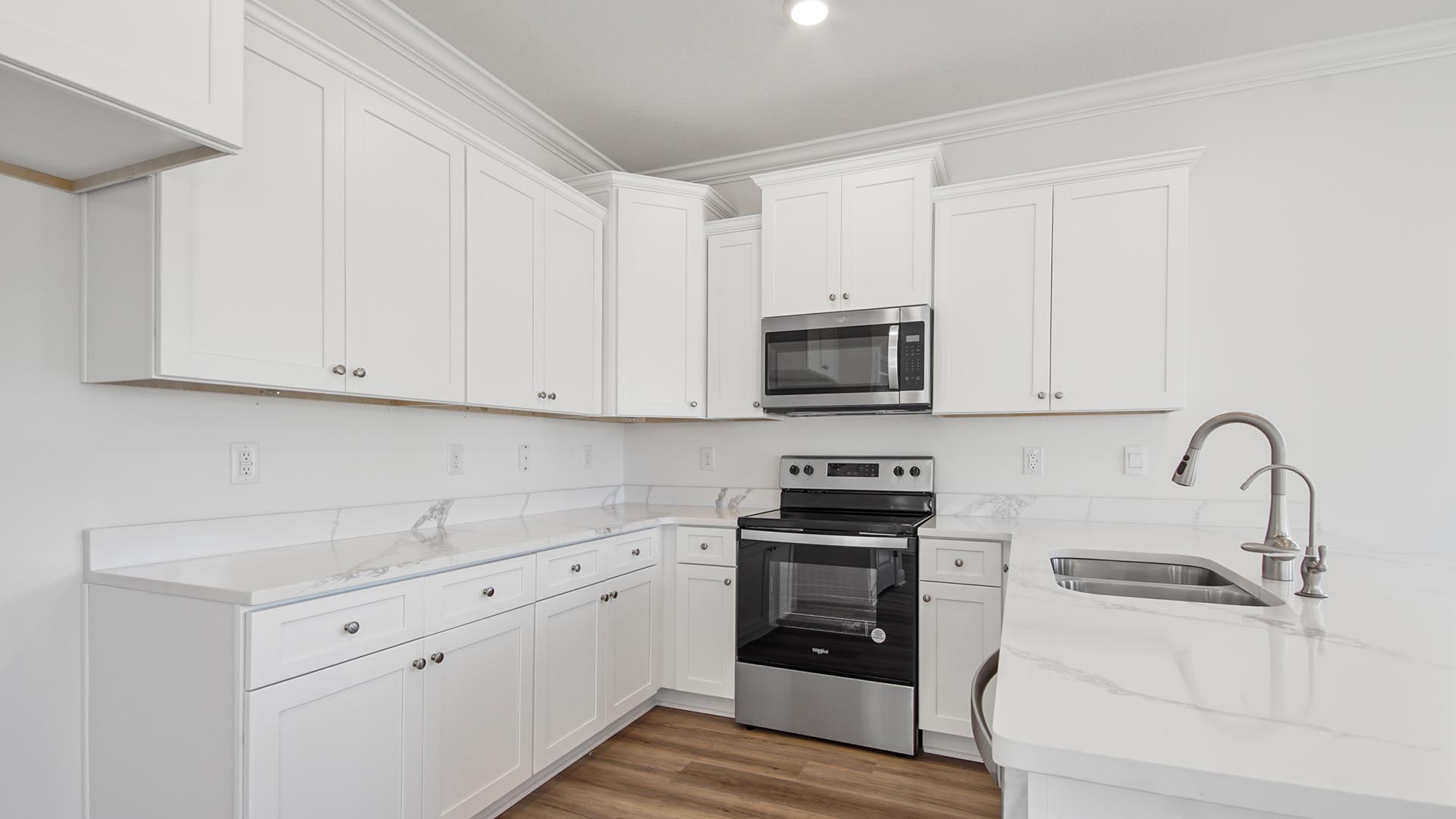 The kitchen has upper and lower cabinetry for storage