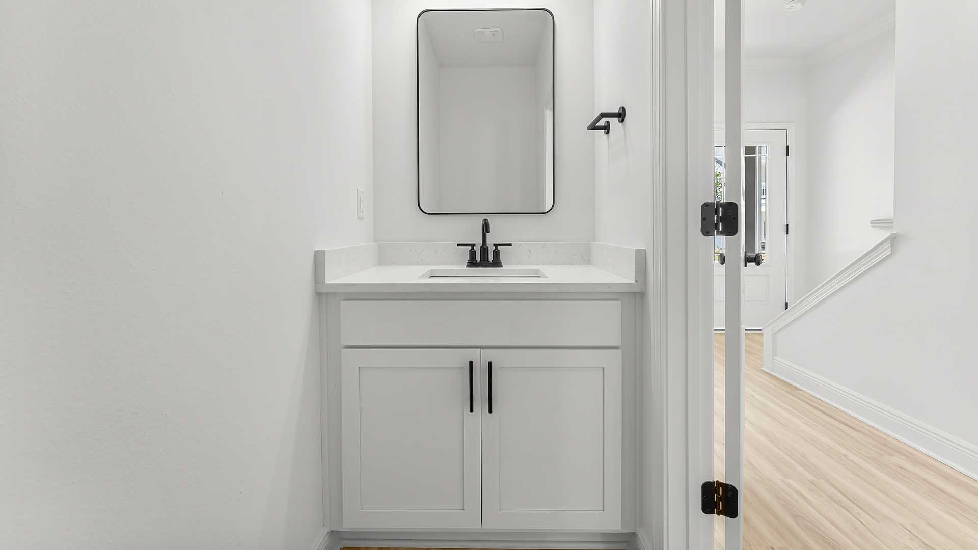 The half bath has a small vanity