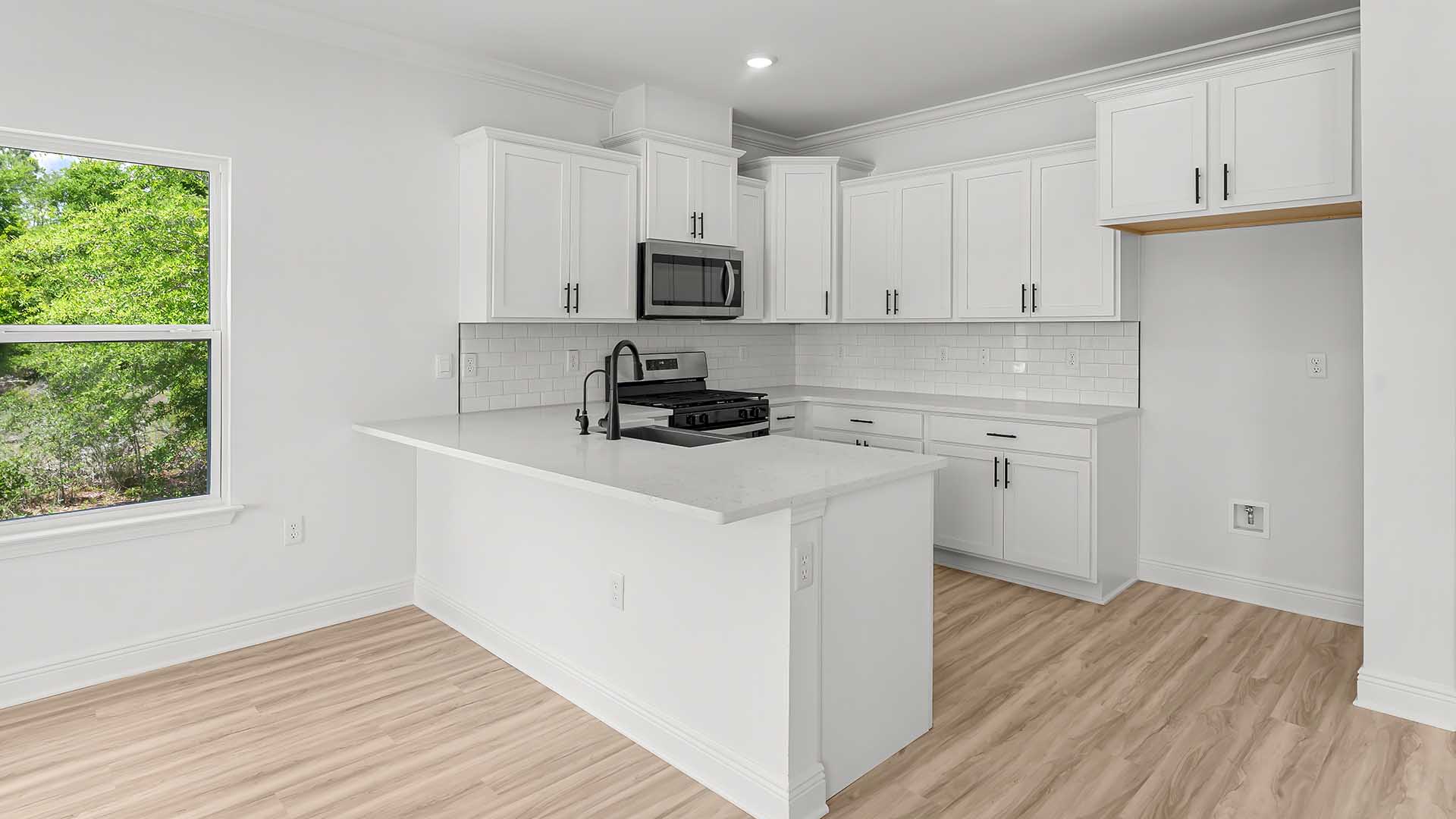 The kitchen has upper and lower cabinetry for storage