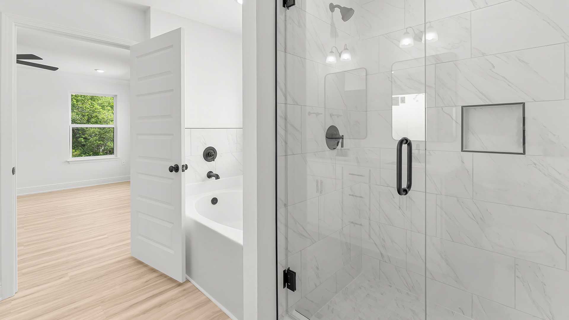 The primary bathroom has a tile shower with glass enclosure