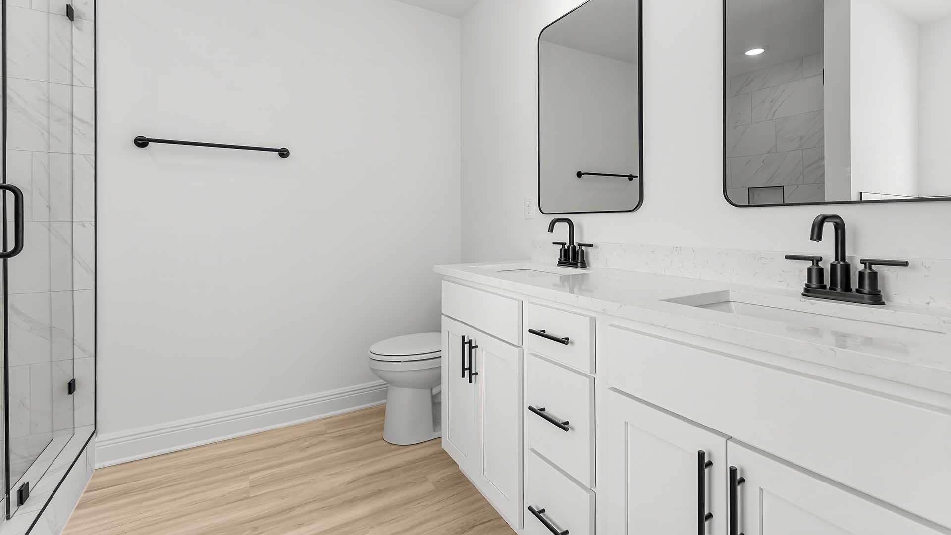The primary bathroom has a dual sink vanity with quartz countertops
