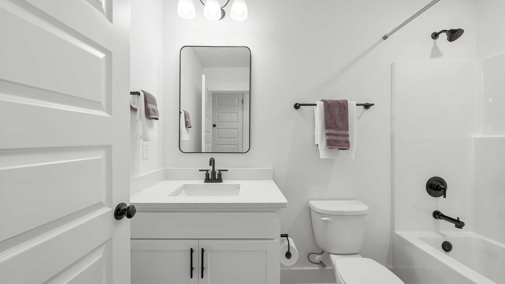 The shared bathroom on the second level has a shower tub combination and a single vanity