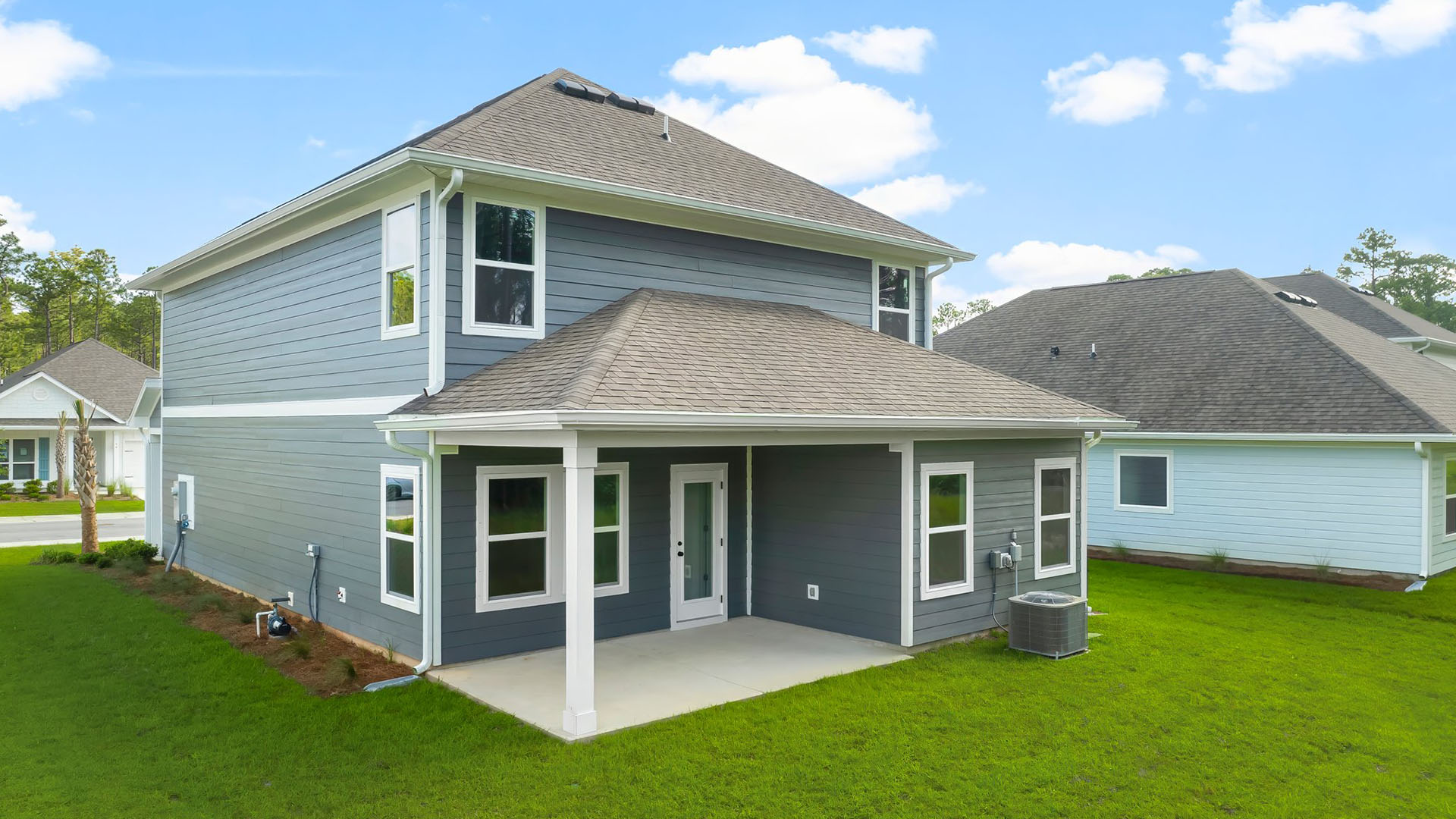 The back the home has a covered patio