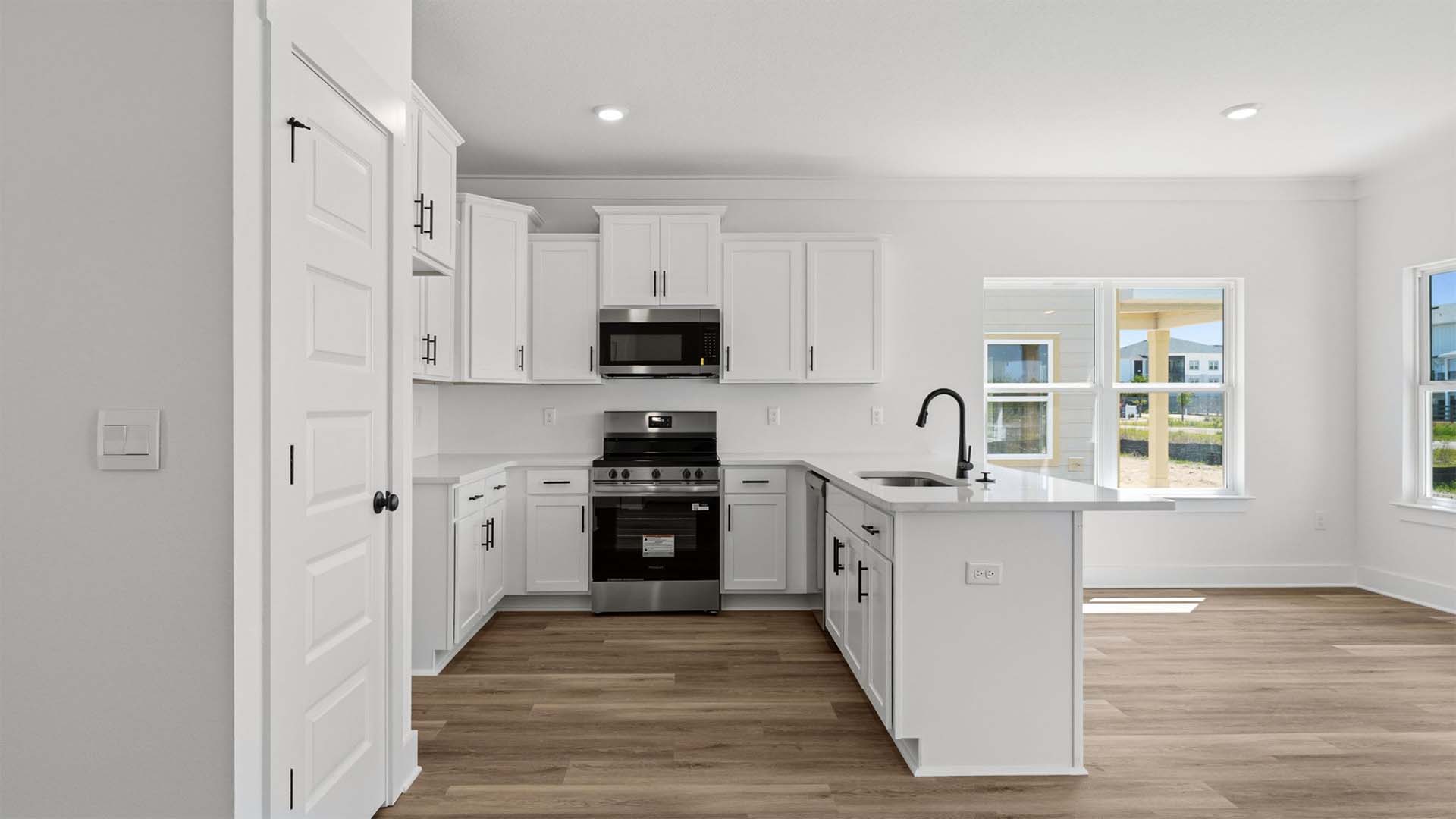 The kitchen features a peninsula bar with space for bar stools