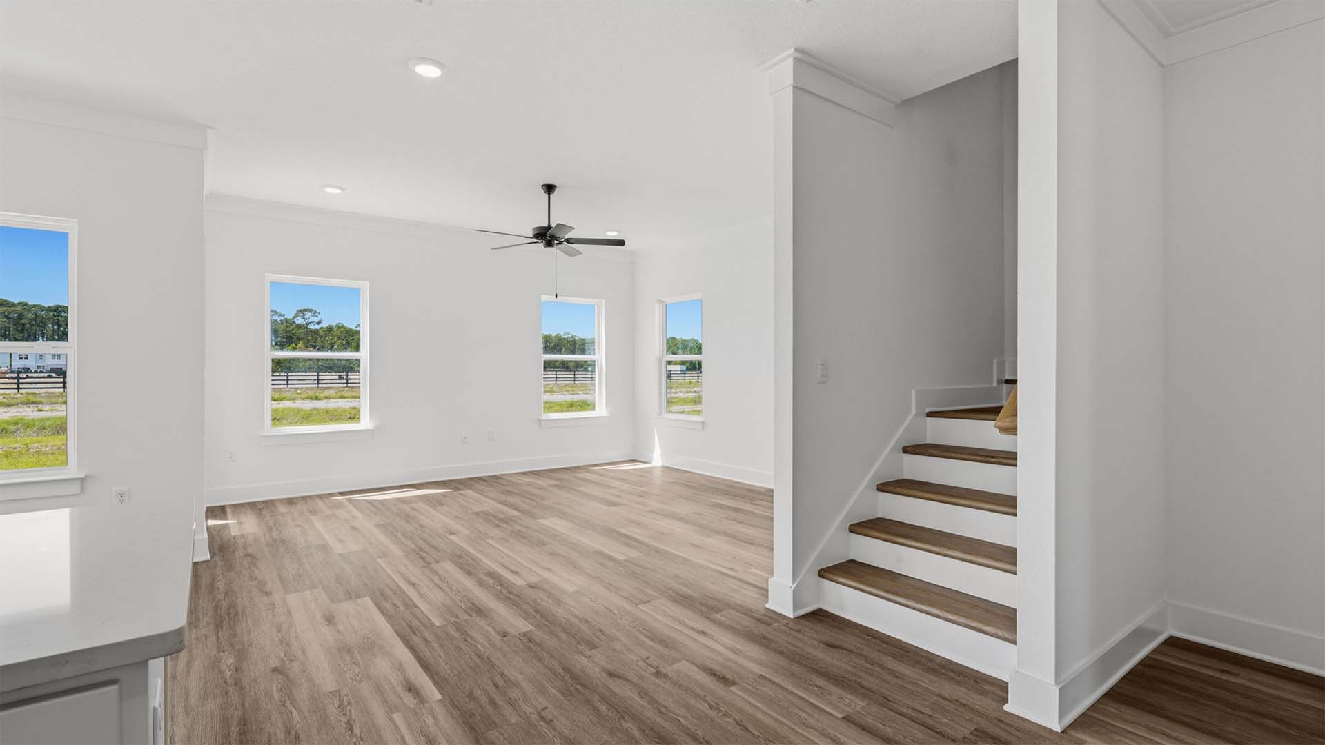 The stairs leading to the second level are just off the kitchen